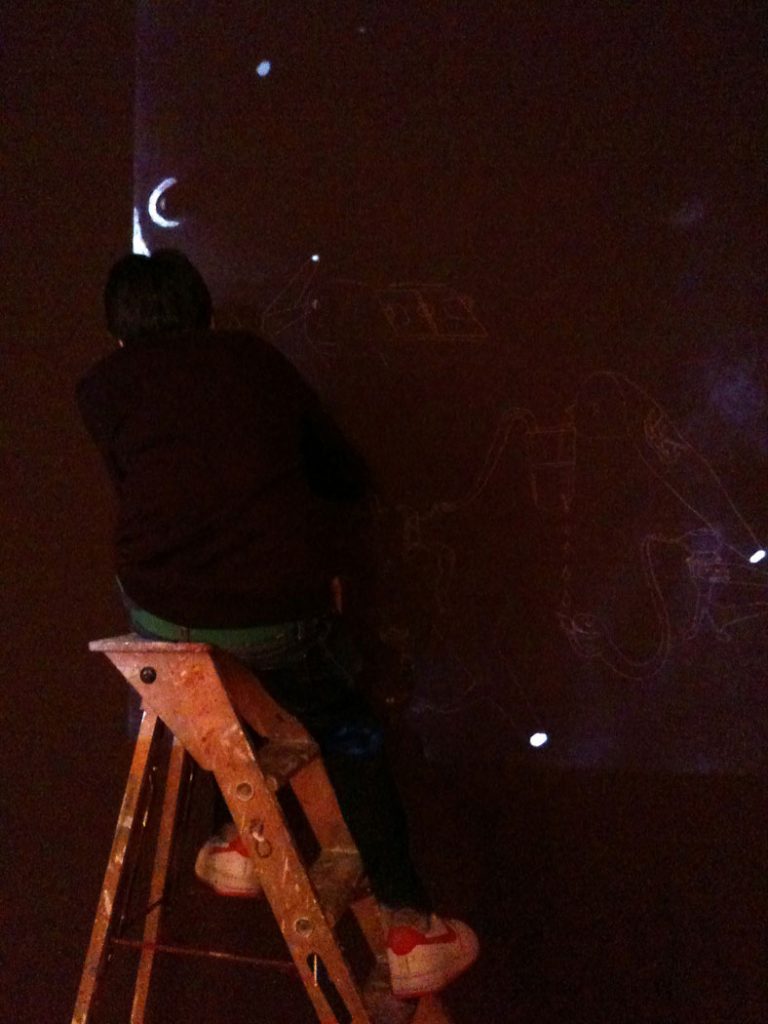 2011, performance snapshot of zoo drawing mural on gallery wall during vernissage