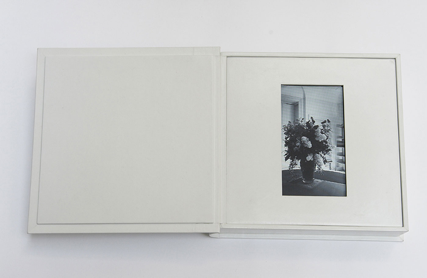 birthday flowers (book open), 2006, 25cm x 25cm x 5,5mm, white leather, dvd player, video duration 10 minute loop